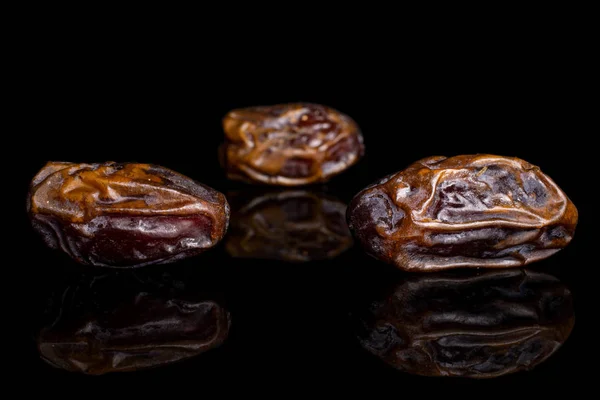 Dry brown date fruit isolated on black glass — ストック写真