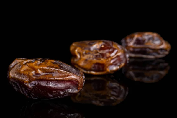 Dry brown date fruit isolated on black glass — ストック写真