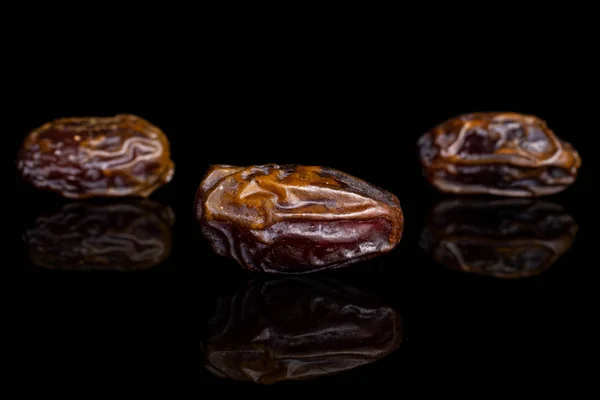 Dry brown date fruit isolated on black glass — ストック写真