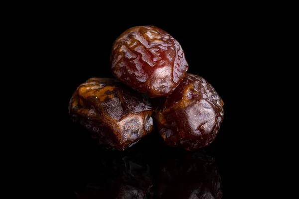 Dry brown date fruit isolated on black glass — Stock Photo, Image