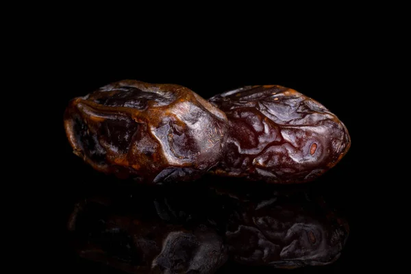 Dry brown date fruit isolated on black glass — ストック写真