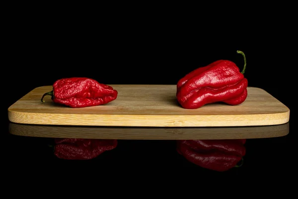 Hot chili pepper isolated on black glass — Stock Photo, Image