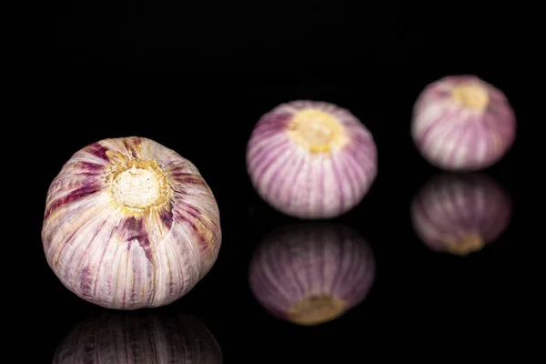 Single clove garlic isolated on black glass — Stockfoto