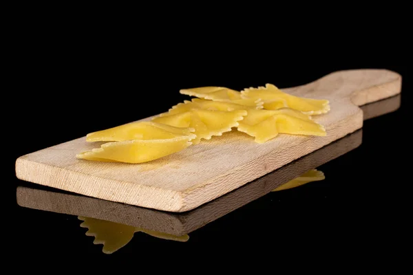 Lot Whole Yellow Pasta Farfalle Wooden Cutting Board Isolated Black — Stock Photo, Image