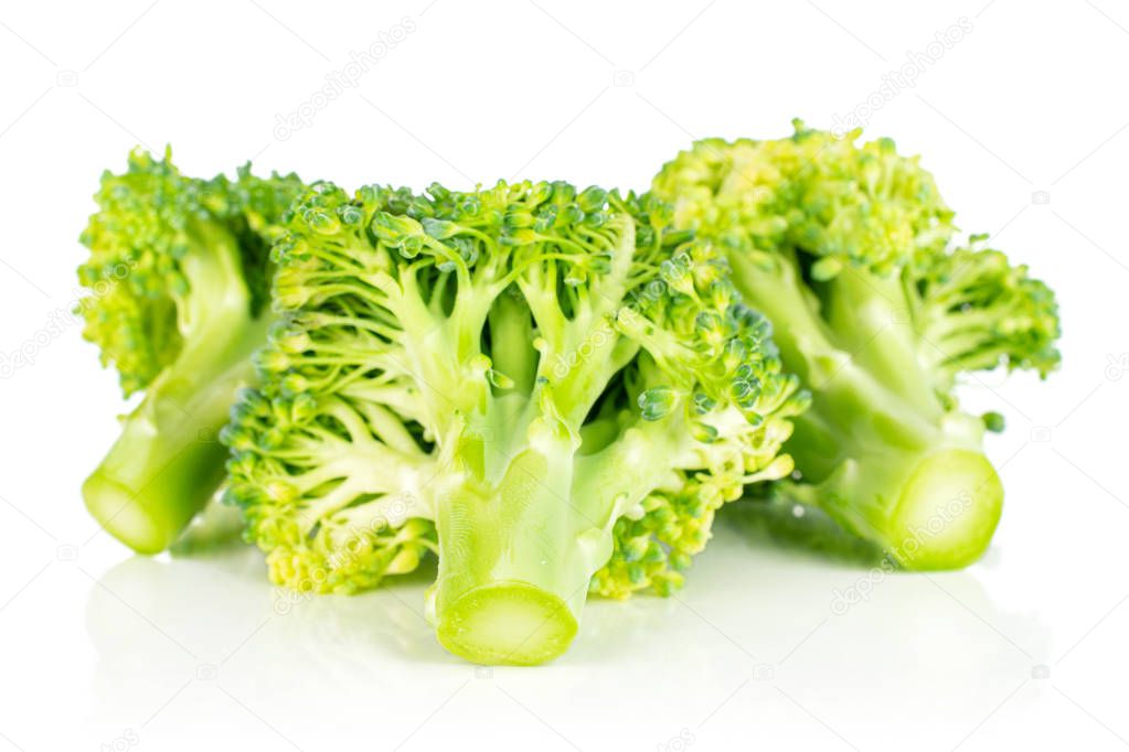 Group of three whole fresh green broccoli head isolated on white background
