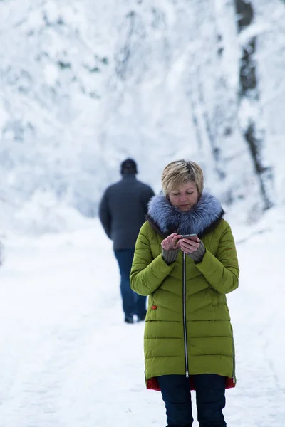 A young woman is walking in the winter forest — Stock Photo, Image