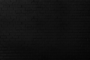 Soyut panoramik siyah tuğla duvar desenli arkaplan ve siyah arkaplan, boş kopya alanı.