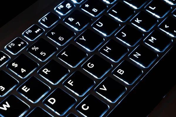 Close-up de teclado preto de um laptop moderno, computador teclas de teclado iluminado — Fotografia de Stock