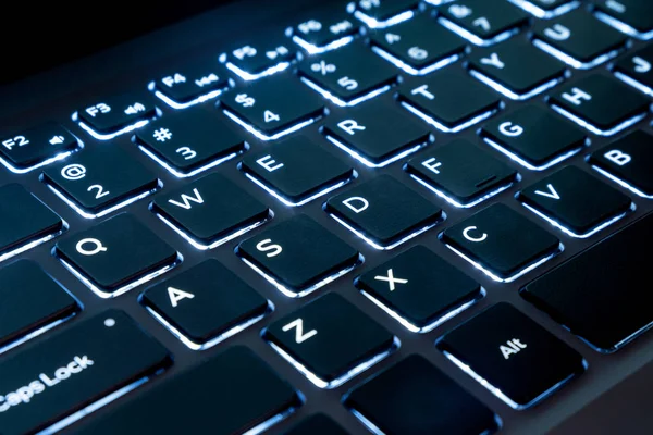 Close up of black keyboard of a modern laptop, Illuminated keyboard keys computer — Stock Photo, Image