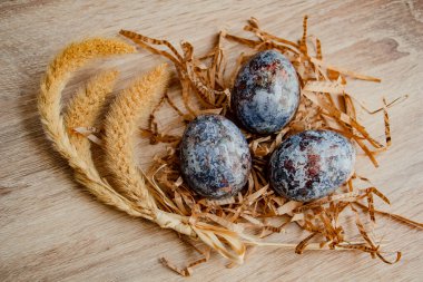 Ahşap arka planda kulakları olan mermer boyalı Paskalya yumurtaları