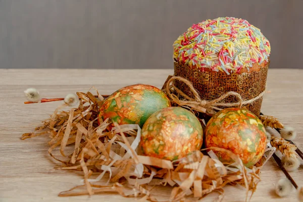 traditional Easter cake and Easter eggs of unusual coloring on the table, close-up
