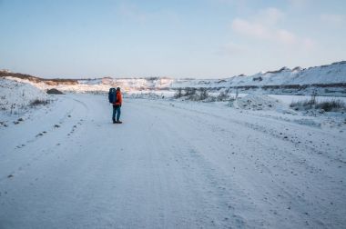 tourist standing on snowy road clipart