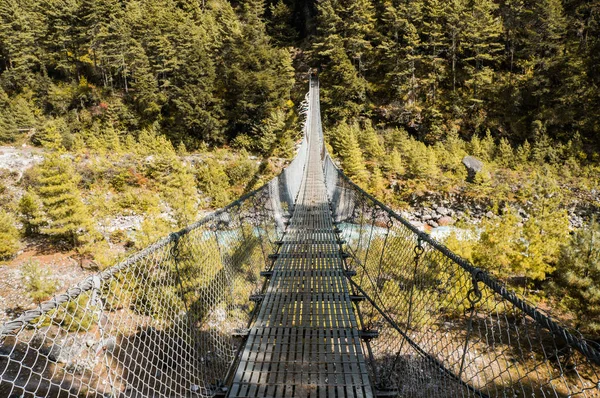 hanging bridge over mountain river