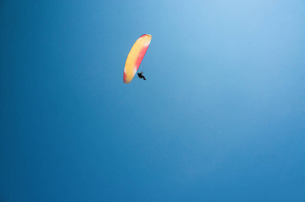 man flying on paraglider 