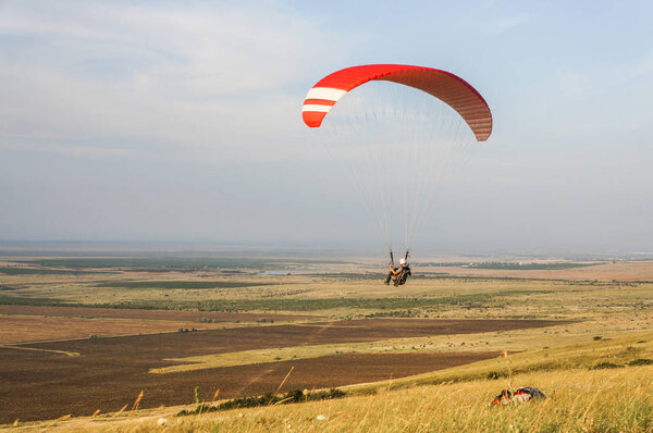 person flying on paraplane