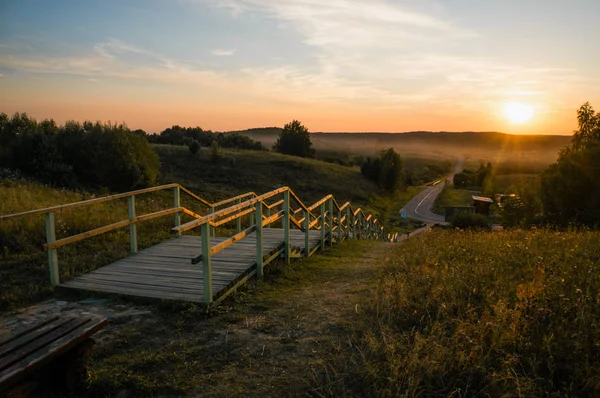 Wooden stairs at sunset — Stock Photo, Image