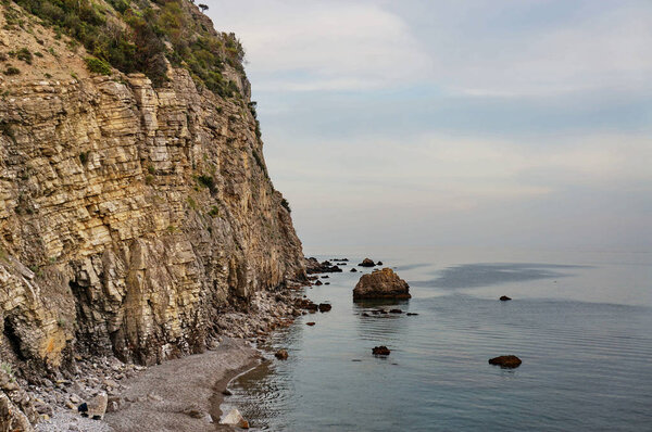 Rock cliffs on coast of sea