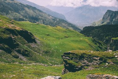 majestic rocky mountains covered with green grass and moss in Indian Himalayas, Rohtang Pass clipart