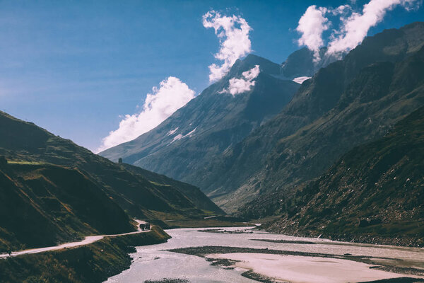scenic landscape with river in majestic valley and road with vehicles in indian himalayas