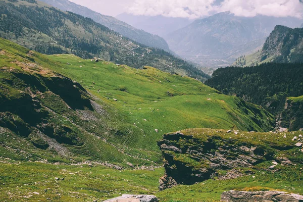 majestic rocky mountains covered with green grass and moss in Indian Himalayas, Rohtang Pass