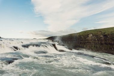 beautiful waterfall landscape with flowing river in Iceland  clipart