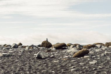 beautiful landscape with rocks and cloudy sky in Iceland clipart