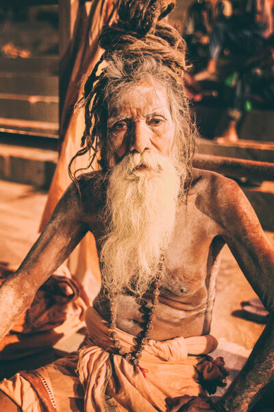 Sadhu man with traditional painted face and body in Varanasi, India