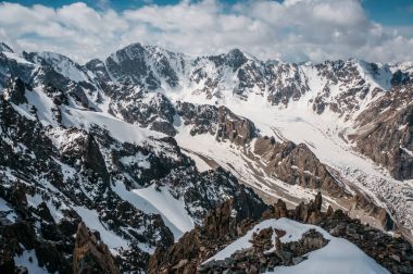 view of mountains rocky peaks in snow under clouds, Ala Archa National Park, Kyrgyzstan clipart