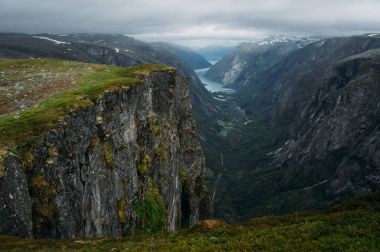 view of rocks and grassy cliff, mountain river on background, Norway, Hardangervidda National Park clipart