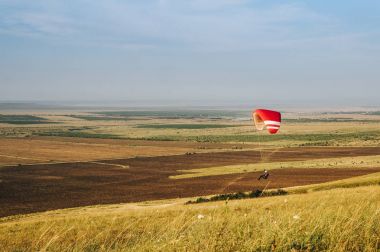 Parachutist flying over beautiful nature of Carpathians, Ukraine, May 2016 clipart