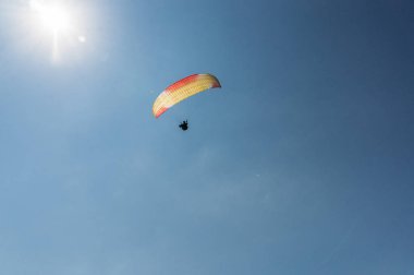 Parachutist flying in blue clear sky, Crimea, Ukraine, May 2013 clipart
