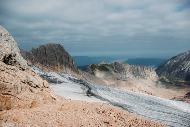 scenic view of rocky cliff and cloudy sky, Caucasus, Russia clipart