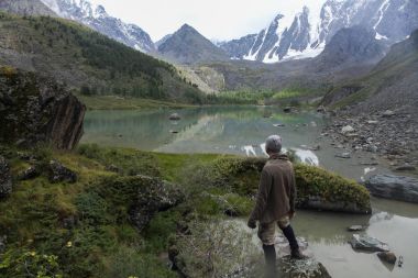 back view of man looking at mountains in Altai, Russia clipart