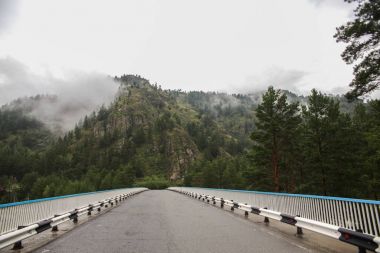 beautiful mountain landscape and asphalt road at cloudy day, Altai, Russia clipart
