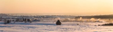 beautiful winter landscape and village at countryside at sunset, kazan region, russia clipart