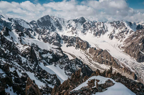 view of mountains rocky peaks in snow under clouds, Ala Archa National Park, Kyrgyzstan