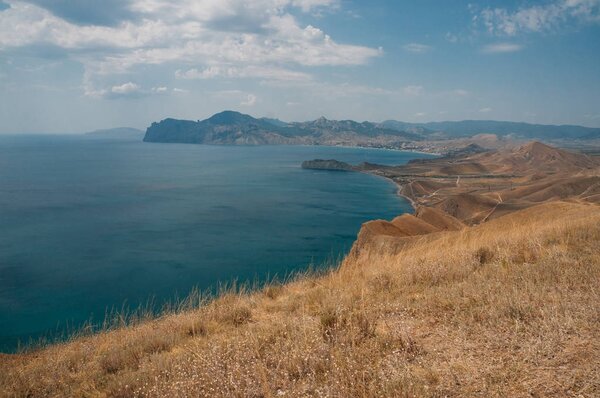 Scenic calm seashore with Crimean mountains ridge, Ukraine, May 2013