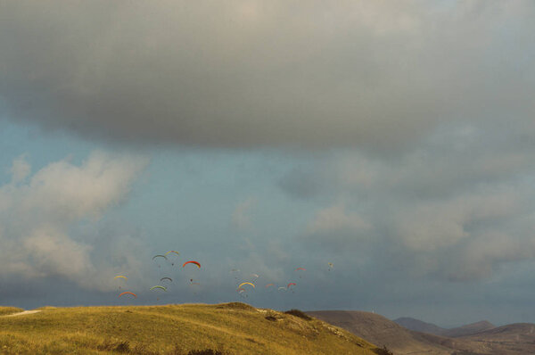 Mountainous landscape with paratroopers flying in the sky, Crimea, Ukraine, May 2013