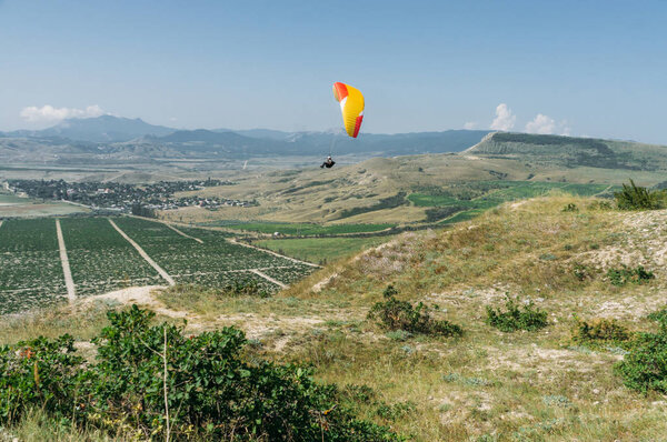 Parachute in the sky over field in hillside area of Crimea, Ukraine, May 2013