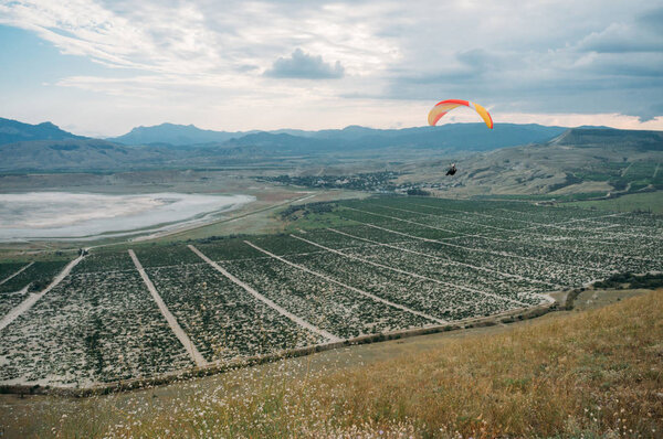 Parachute in the sky over field in hillside area of Crimea, Ukraine, May 2013