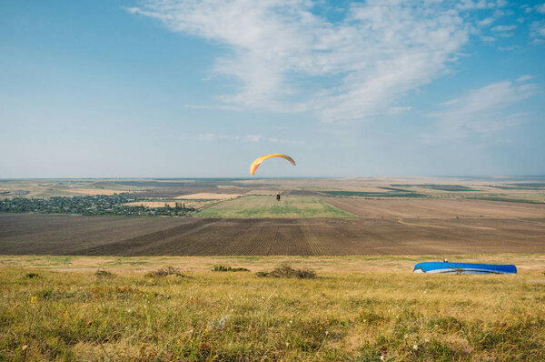 Parachutists gliding in blue sky over scenic landscape of Crimea, Ukraine, May 2013