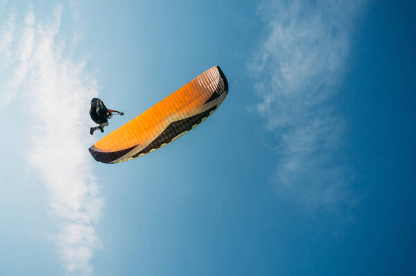 Parachutist flying in blue clear sky, Crimea, Ukraine, May 2013