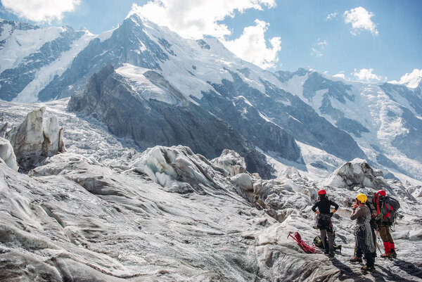 hikers standing and looking at beautiful mountains, Russian Federation, Caucasus, July 2012
