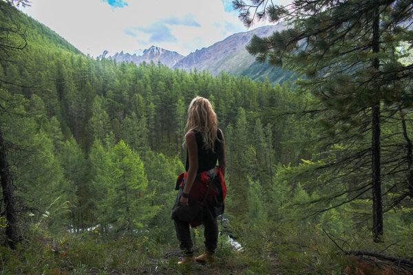 back view of woman looking at mountains, Altai, Russia