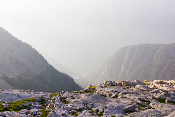 rocks and beautiful mountains at foggy sunrise, alps, switzerland