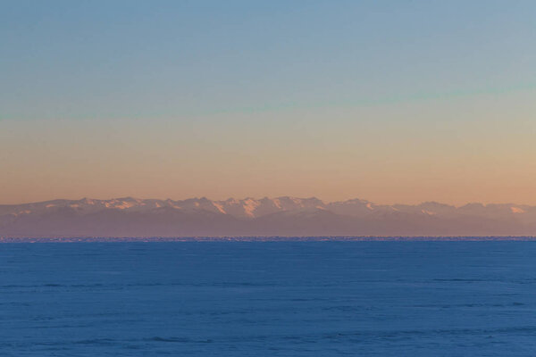 beautiful lake and mountains in fog at sunrise, Baikal, Russia