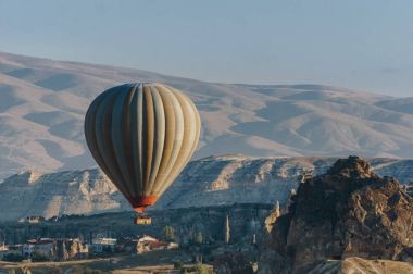 Hot air balloon flying in Goreme national park, fairy chimneys, Cappadocia, Turkey clipart