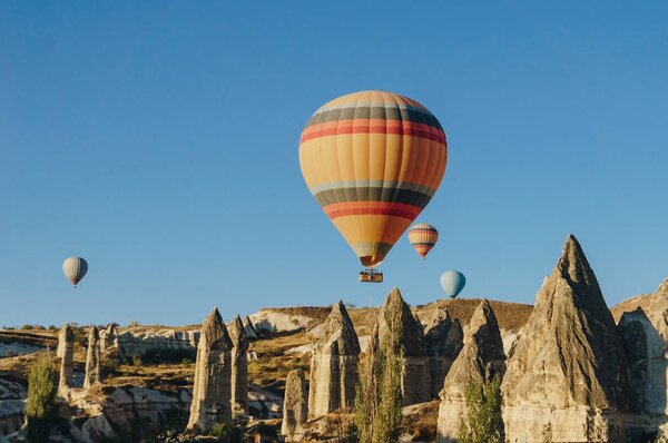 Hot air balloons flying in Goreme national park, fairy chimneys, Cappadocia, Turkey