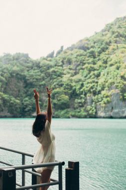 woman standing with hands up at Ang Thong National Park, Ko Samui, Thailand clipart