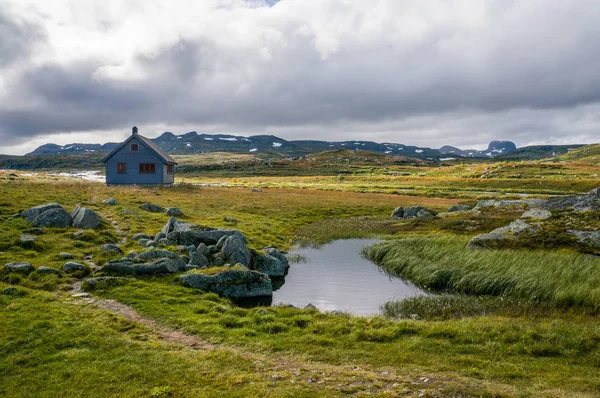 House on meadow with river — Stock Photo